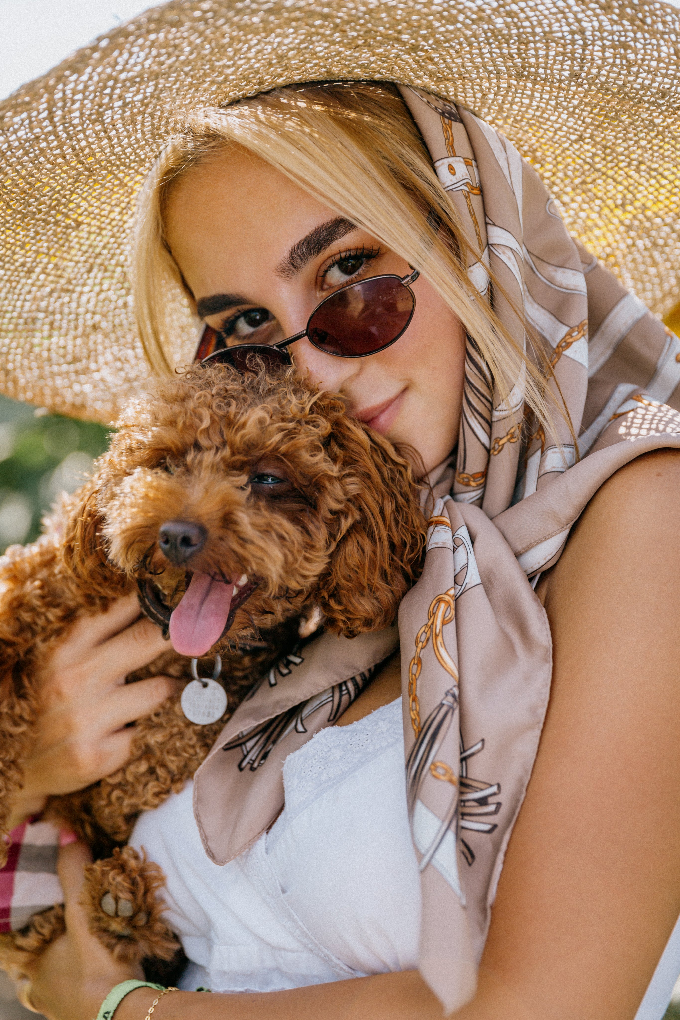 files/woman-holds-a-small-brown-puppy-close-outdoors.jpg